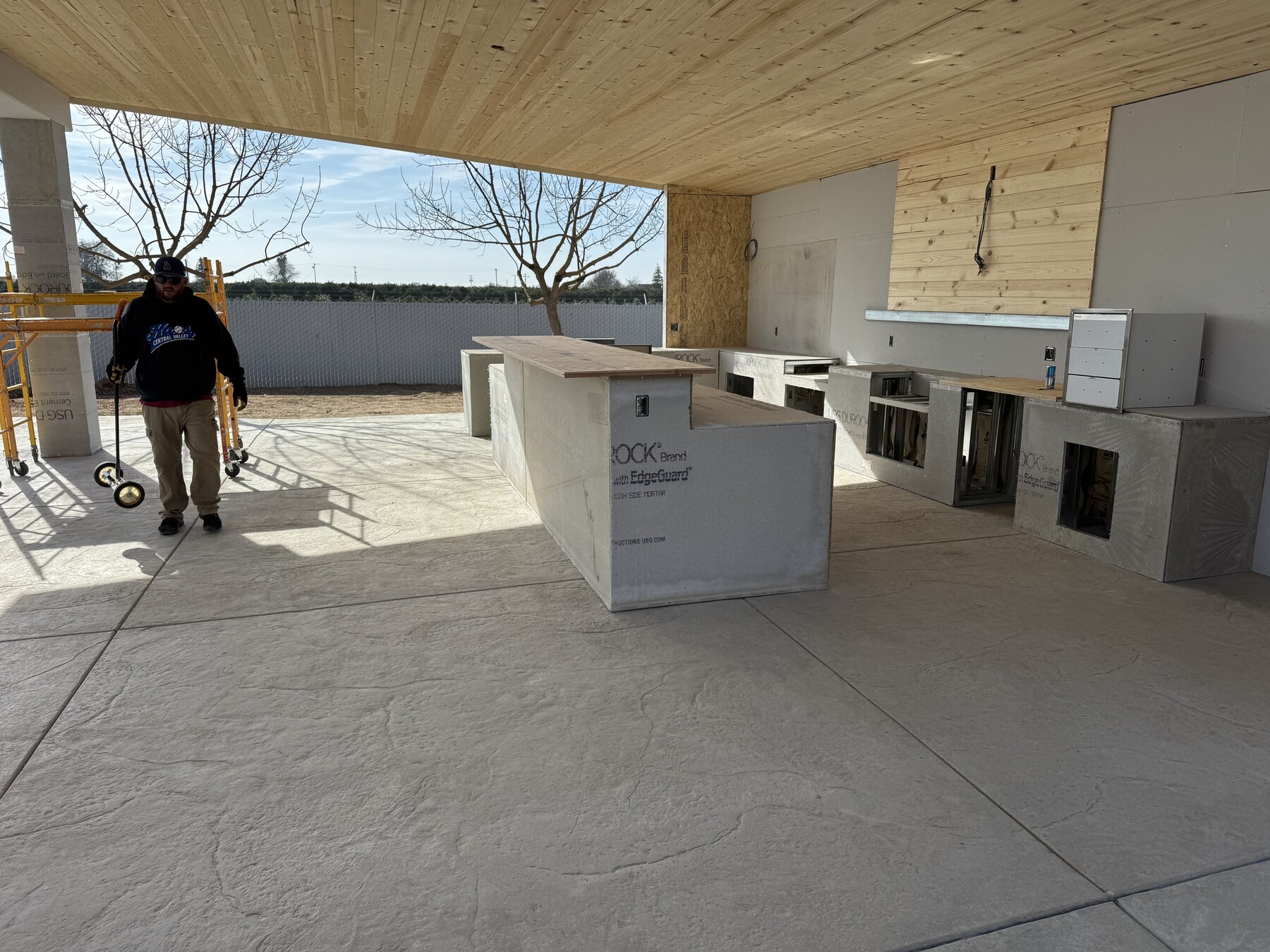 Bradley Commercial Interiors crew member at the Ferris outdoor kitchen cement board install