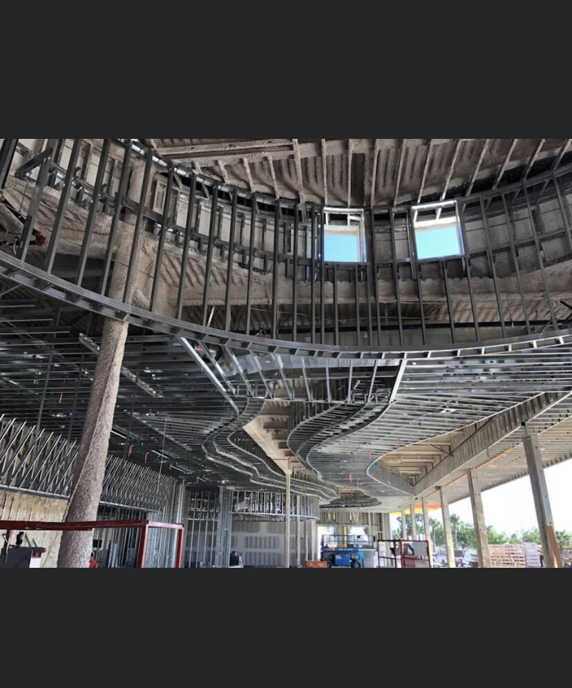 Curved steel dome ceiling framing with skylights by Bradley Commercial Interiors