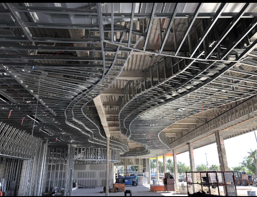 Curved steel track ceiling framing by Bradley Commercial Interiors