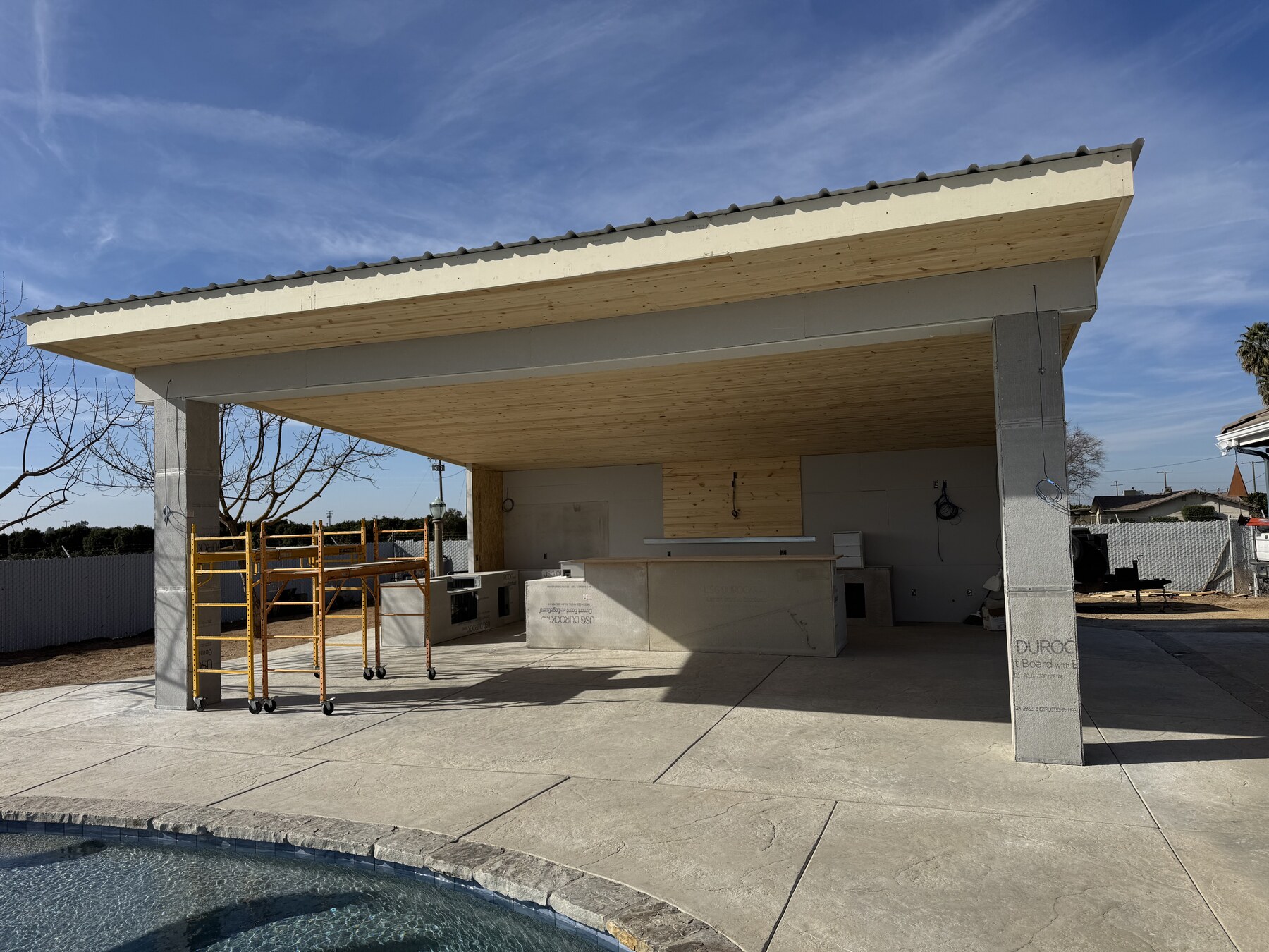 Ferris poolside outdoor kitchen and canopy structure with cement board by Bradley Commercial Interiors